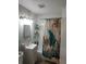 Clean bathroom features a shower with turtle themed curtain and classic fixtures at 310 4Th Ave. Southwest, Ruskin, FL 33570