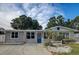 Charming single-story home with a well-maintained lawn, blue front door, and updated windows at 310 4Th Ave. Southwest, Ruskin, FL 33570