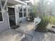 Covered front porch with an outdoor mat, lush tropical foliage, and a white mailbox by the home's entrance at 310 4Th Ave. Southwest, Ruskin, FL 33570