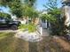 The front yard features tropical foliage, a driveway with a truck and boat, and a charming entrance at 310 4Th Ave. Southwest, Ruskin, FL 33570