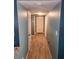 Long hallway with modern floors and doors lining both walls at 310 4Th Ave. Southwest, Ruskin, FL 33570