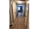 Hallway with modern floors leads to a living space that features a unique papasan chair at 310 4Th Ave. Southwest, Ruskin, FL 33570