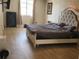 Cozy main bedroom featuring a plush bed, contemporary lighting, and wood-look flooring at 310 4Th Ave. Southwest, Ruskin, FL 33570