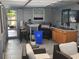 Inviting screened outdoor living space with cozy seating, grill, and mounted television for ultimate entertaining and relaxation at 310 4Th Ave. Southwest, Ruskin, FL 33570