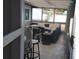 Enclosed outdoor area with tiled floors, comfortable seating, and a ceiling fan for relaxed and private entertaining at 310 4Th Ave. Southwest, Ruskin, FL 33570