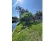 Spacious backyard with a waterfront view, lush landscaping, and an enclosed patio, perfect for outdoor enjoyment at 3111 S Canal Dr, Palm Harbor, FL 34684