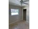 Bedroom features tile flooring, a ceiling fan, and closet at 3111 S Canal Dr, Palm Harbor, FL 34684