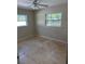 Bedroom features tile flooring and two windows at 3111 S Canal Dr, Palm Harbor, FL 34684