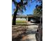 Exterior view of a one-story home with a covered carport and well-kept lawn on a sunny day at 3111 S Canal Dr, Palm Harbor, FL 34684