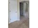 Hallway to a room with tile floors and white doors at 3111 S Canal Dr, Palm Harbor, FL 34684