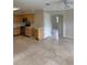 Spacious kitchen with ample cabinet space, stainless steel appliances, and tile floors, adjoining a bright and open living area at 3111 S Canal Dr, Palm Harbor, FL 34684