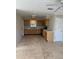 Open kitchen with light wood cabinets, neutral countertops, and tile flooring in a spacious layout at 3111 S Canal Dr, Palm Harbor, FL 34684