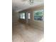 Living room featuring tile flooring, ceiling fan, and views to screened in patio at 3111 S Canal Dr, Palm Harbor, FL 34684