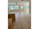 Open concept living room with tile flooring, neutral paint and views to backyard at 3111 S Canal Dr, Palm Harbor, FL 34684
