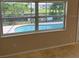 View of a swimming pool from a window with views of backyard at 3111 S Canal Dr, Palm Harbor, FL 34684