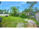 Backyard with green grass and a partially fenced perimeter at 312 E Tomlin St, Plant City, FL 33563