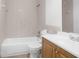 Bathroom features white tile, a white vanity, and bathtub at 312 E Tomlin St, Plant City, FL 33563