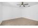 Minimalist bedroom with neutral walls, tiled floor and a modern ceiling fan at 312 E Tomlin St, Plant City, FL 33563