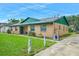 Well-maintained single story home with a green roof and a sidewalk leading to the front door at 312 E Tomlin St, Plant City, FL 33563