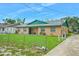 Charming single-story home featuring a well-maintained lawn and a classic stucco facade at 312 E Tomlin St, Plant City, FL 33563