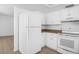 Well-lit kitchen featuring all-white appliances and cabinetry with modern tile floors at 312 E Tomlin St, Plant City, FL 33563