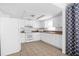 Bright kitchen featuring all-white cabinets, appliances, and tile flooring at 312 E Tomlin St, Plant City, FL 33563