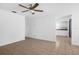 Bright living room with tile flooring, ceiling fan, and an open layout flowing into the kitchen at 312 E Tomlin St, Plant City, FL 33563