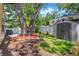 Spacious backyard with a shed, mature trees, lush lawn and a privacy fence at 3129 W Villa Rosa St, Tampa, FL 33611