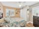 Light bedroom with coastal decor, wood-look floors, plantation shutters, and modern closet at 3129 W Villa Rosa St, Tampa, FL 33611
