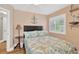 Cozy bedroom with neutral walls, decorative anchor, wood-look floors and shuttered window at 3129 W Villa Rosa St, Tampa, FL 33611