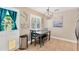 Eat-in kitchen featuring a dining table with chairs, modern lighting, and view of exterior at 3129 W Villa Rosa St, Tampa, FL 33611
