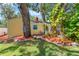 Charming yellow home featuring mature landscaping, red mulch, and a red chimney at 3129 W Villa Rosa St, Tampa, FL 33611