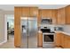 Bright kitchen features stainless steel appliances, wooden cabinets, and granite countertops at 3129 W Villa Rosa St, Tampa, FL 33611