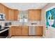 Beautiful kitchen area with stainless appliances, wood cabinets, white countertops, and tile backsplash at 3129 W Villa Rosa St, Tampa, FL 33611