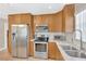 Modern kitchen featuring stainless steel appliances, light wood cabinets, and sleek countertops at 3129 W Villa Rosa St, Tampa, FL 33611