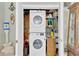 Compact laundry closet with stacked washer and dryer, plus additional storage space at 3129 W Villa Rosa St, Tampa, FL 33611