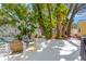 An inviting backyard patio with comfortable seating, shade trees, and lush landscaping at 3129 W Villa Rosa St, Tampa, FL 33611