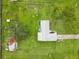 Birds eye view of a home with metal roof, large yard and fencing at 3515 E 34Th St, Bradenton, FL 34208
