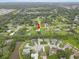 Panoramic aerial view of a neighborhood with houses nestled amongst trees and lakes, bathed in soft daylight at 3515 E 34Th St, Bradenton, FL 34208