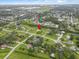 Aerial view of suburban homes with landscaped yards, near ponds and wetlands, under a vast blue sky at 3515 E 34Th St, Bradenton, FL 34208