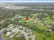Expansive aerial image showcasing a community near ponds, surrounded by dense trees, under a partly cloudy sky at 3515 E 34Th St, Bradenton, FL 34208