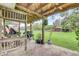 Covered porch with hanging lights and grill at 3515 E 34Th St, Bradenton, FL 34208