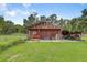Exterior view of the barn featuring barn door and lush lawn at 3515 E 34Th St, Bradenton, FL 34208