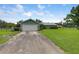 Home exterior with a wide driveway and green lawn at 3515 E 34Th St, Bradenton, FL 34208