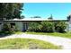 Charming single-story home featuring mature landscaping and a brick driveway at 3811 Huntington Ne St, St Petersburg, FL 33703