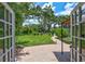 The backyard includes a brick patio, lush green lawn, and mature landscaping at 3923 Hudson Ln, Tampa, FL 33618