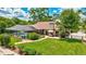 Lovely backyard features a screened-in pool, lush landscaping, and a spacious brick-paved area at 3923 Hudson Ln, Tampa, FL 33618