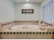 Elegant soaking tub featuring decorative tile work and glass block window at 3923 Hudson Ln, Tampa, FL 33618