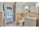 Elegant bathroom with tiled walls, modern vanity, and direct access to the pool at 3923 Hudson Ln, Tampa, FL 33618