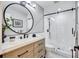 Modern bathroom with vanity, round mirror, and glass-enclosed shower at 3923 Hudson Ln, Tampa, FL 33618